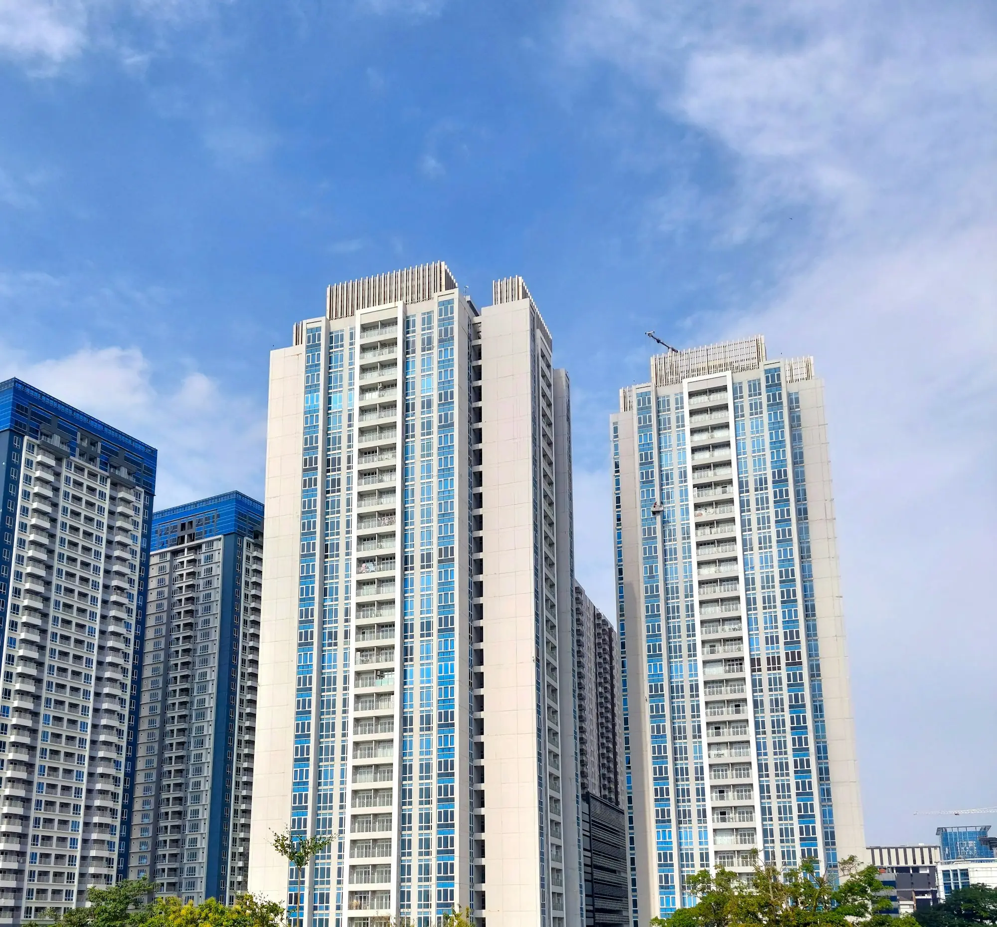 White residential towers against a blue sky